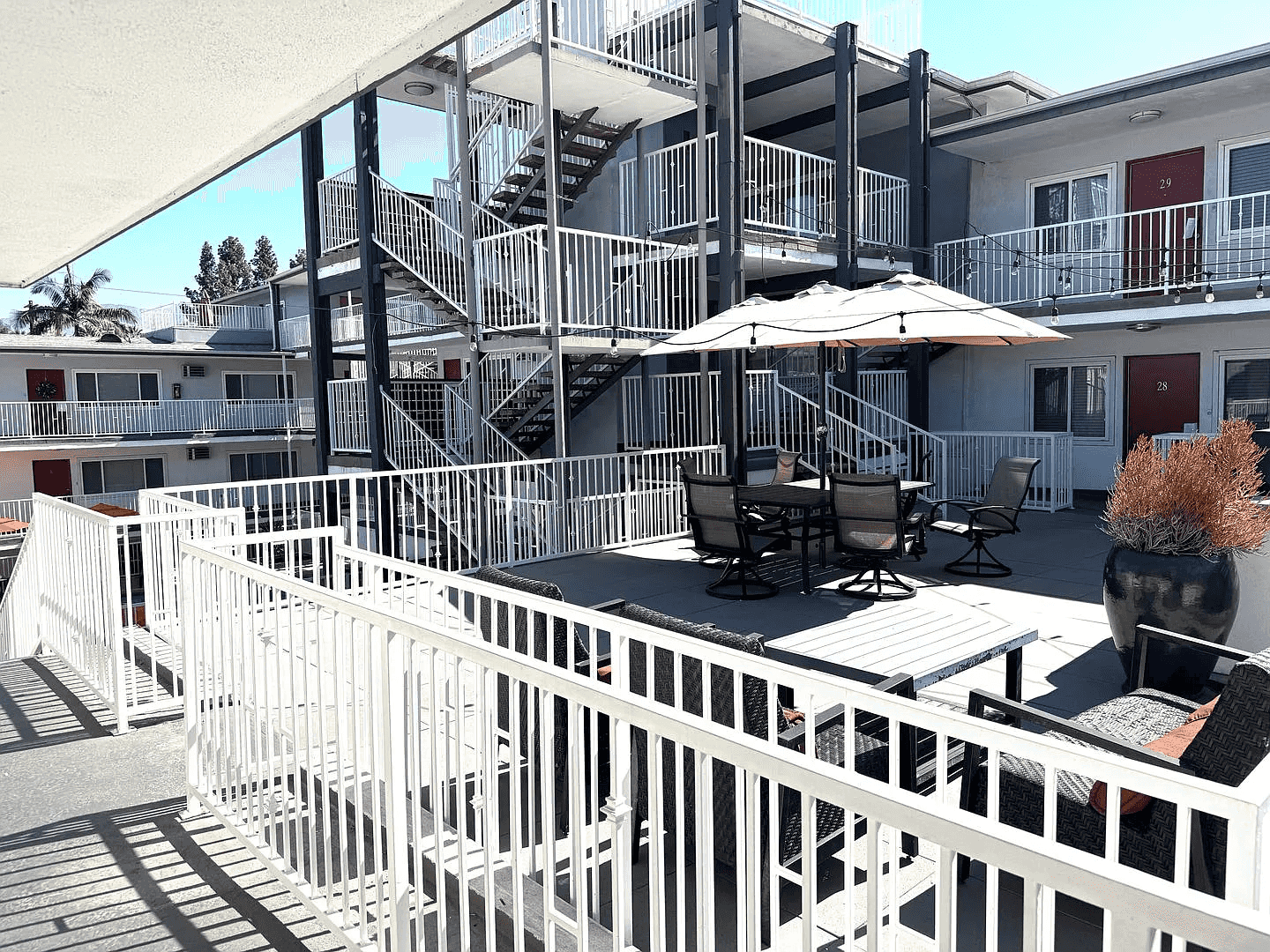 rooftop patio with dining area and umbrellas