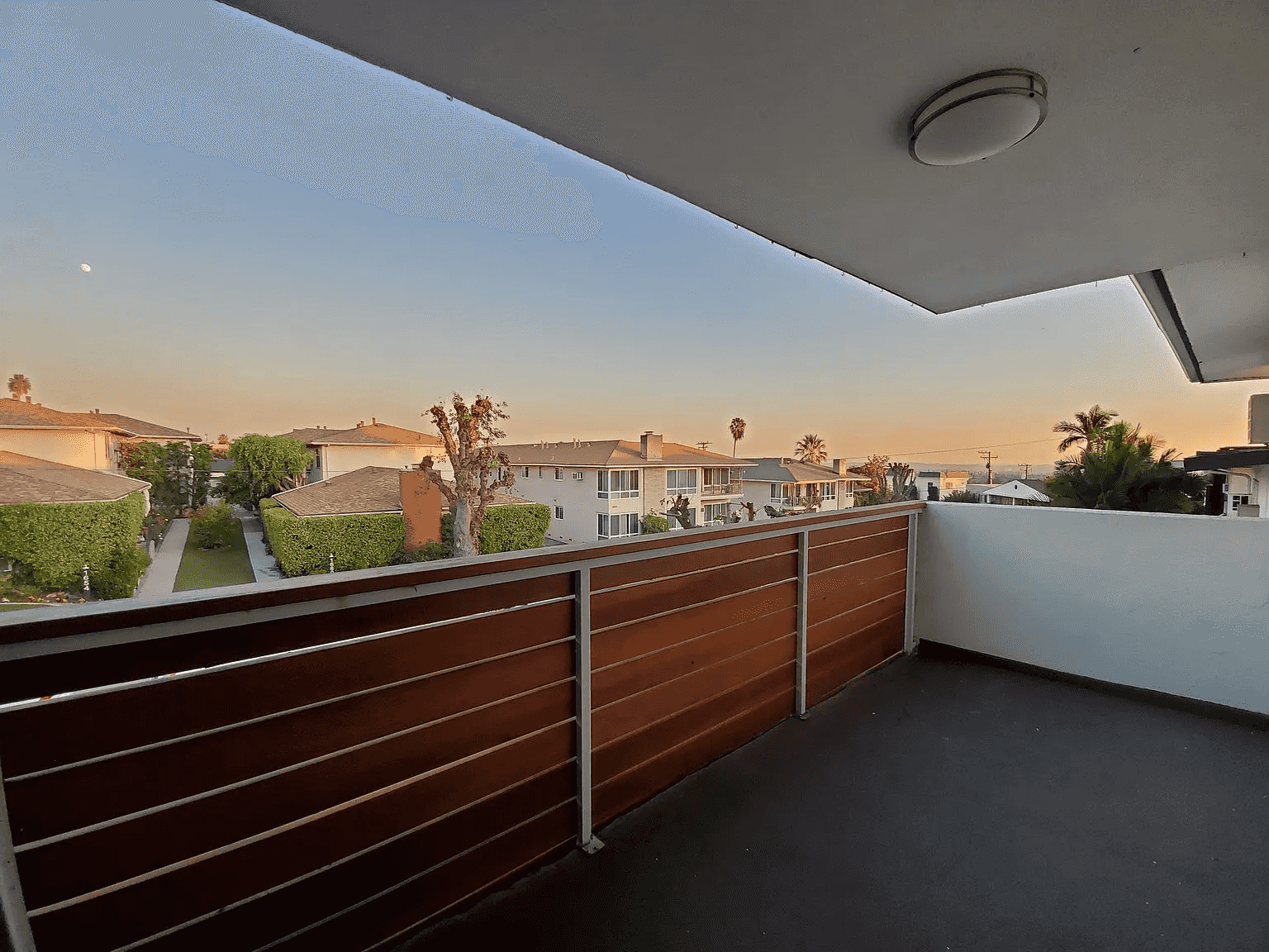 private balcony with neighborhood sunset views