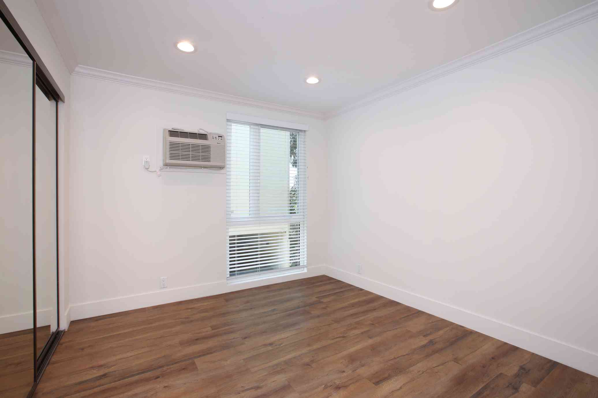 bedroom interior with recessed lighting and closet