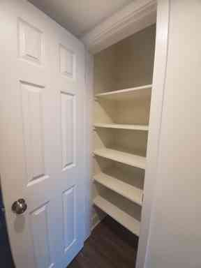 linen closet with built in shelving storage
